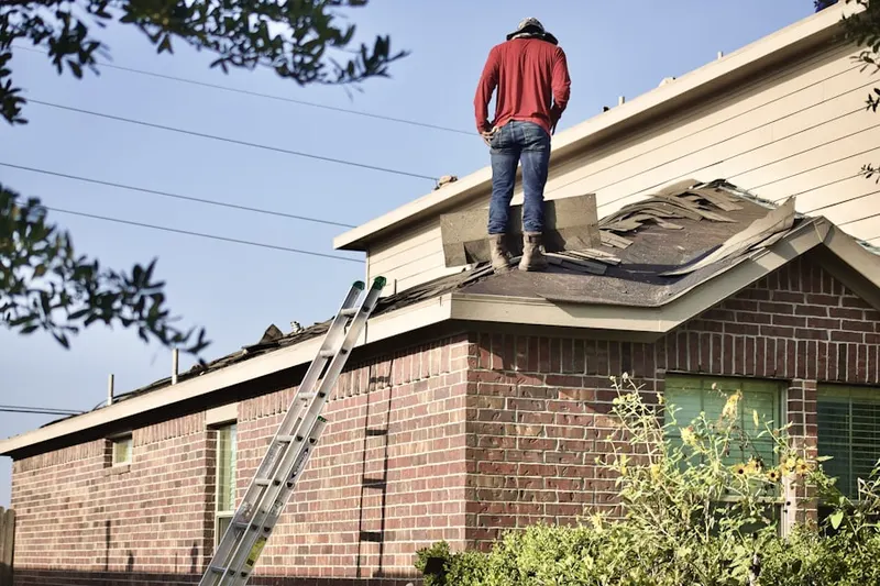 Professional roofer working on a residential roof in Vernoy